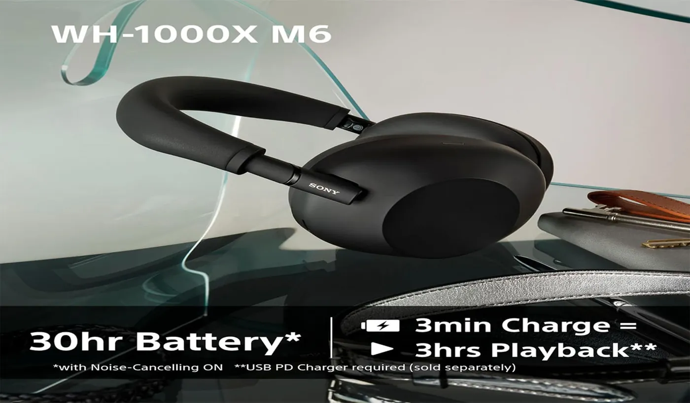 Sony WH-1000XM6 headphones resting beside a laptop for a work-from-home listening setup